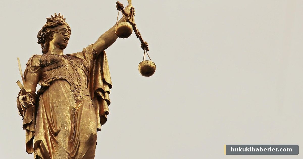 Elinde adalet terazisi ve kılıç tutan altın renkli heykel figürü