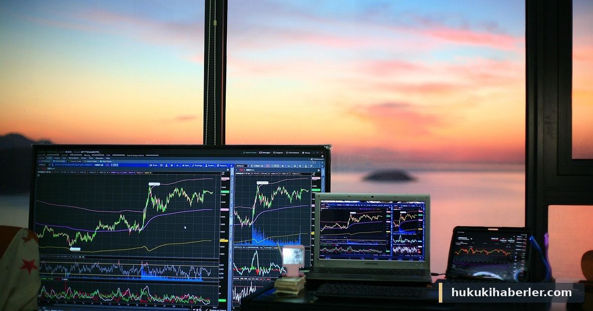 Gün batımında denize bakan bir odada borsa grafikleri gösteren monitörler